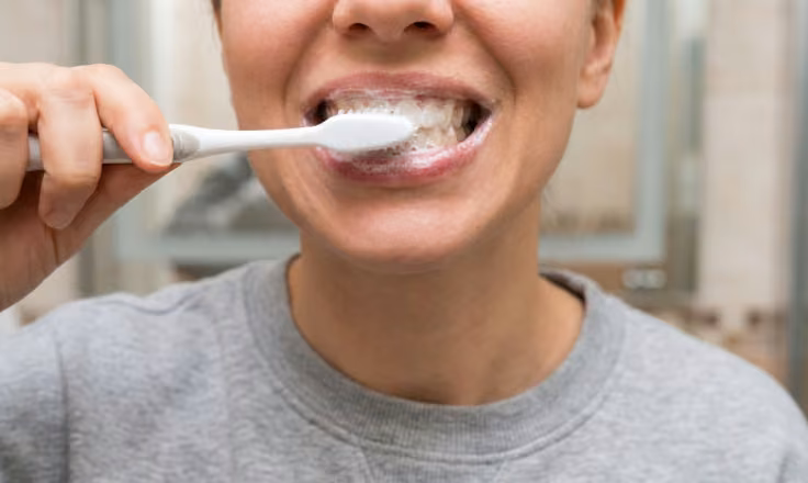 Up-close shot of a woman mid-brush